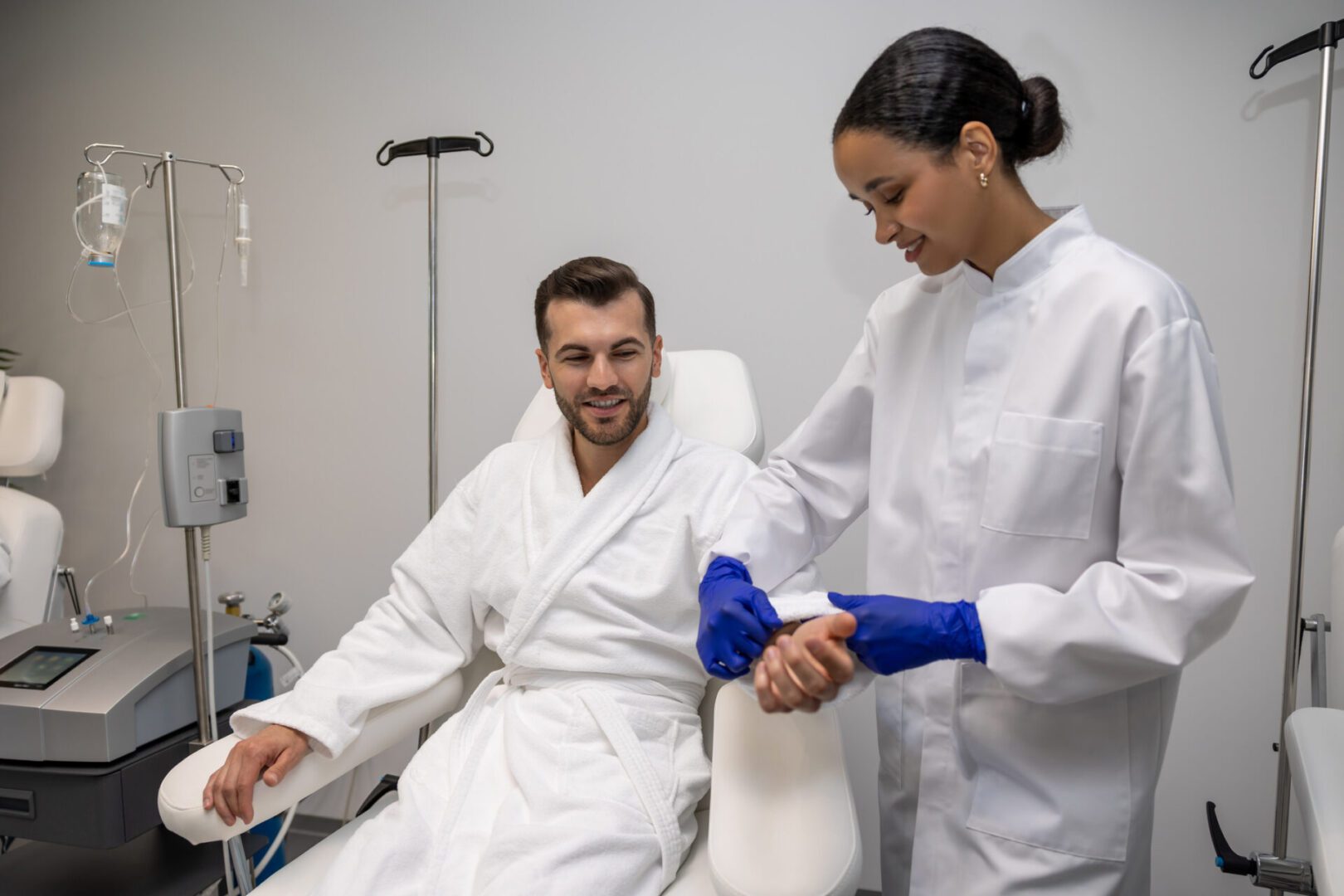 Healthcare worker assisting patient in chair