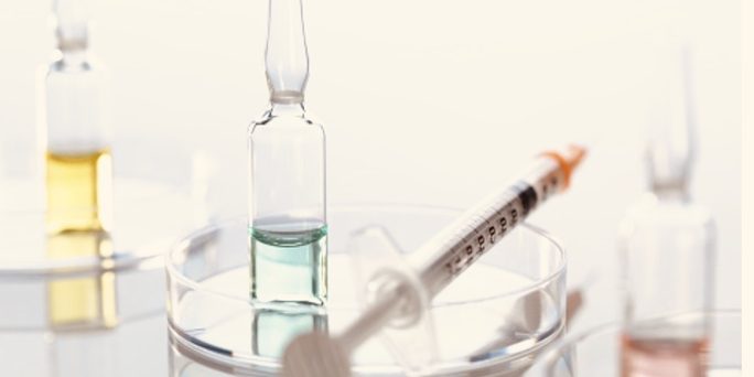 Syringe and ampoules on a petri dish