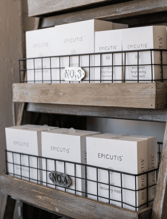 Epicutis skincare boxes on rustic wooden shelves